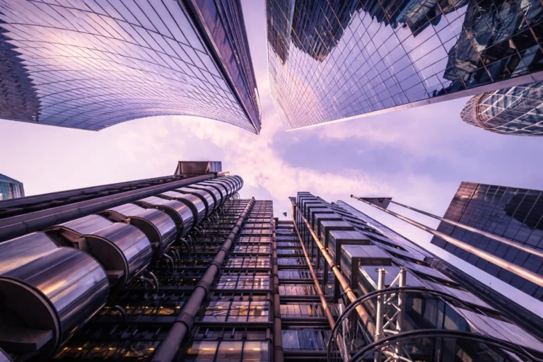 Low angle view of modern glass office skyscrapers, symbolizing business scaling and corporate growth through CRM infrastructure